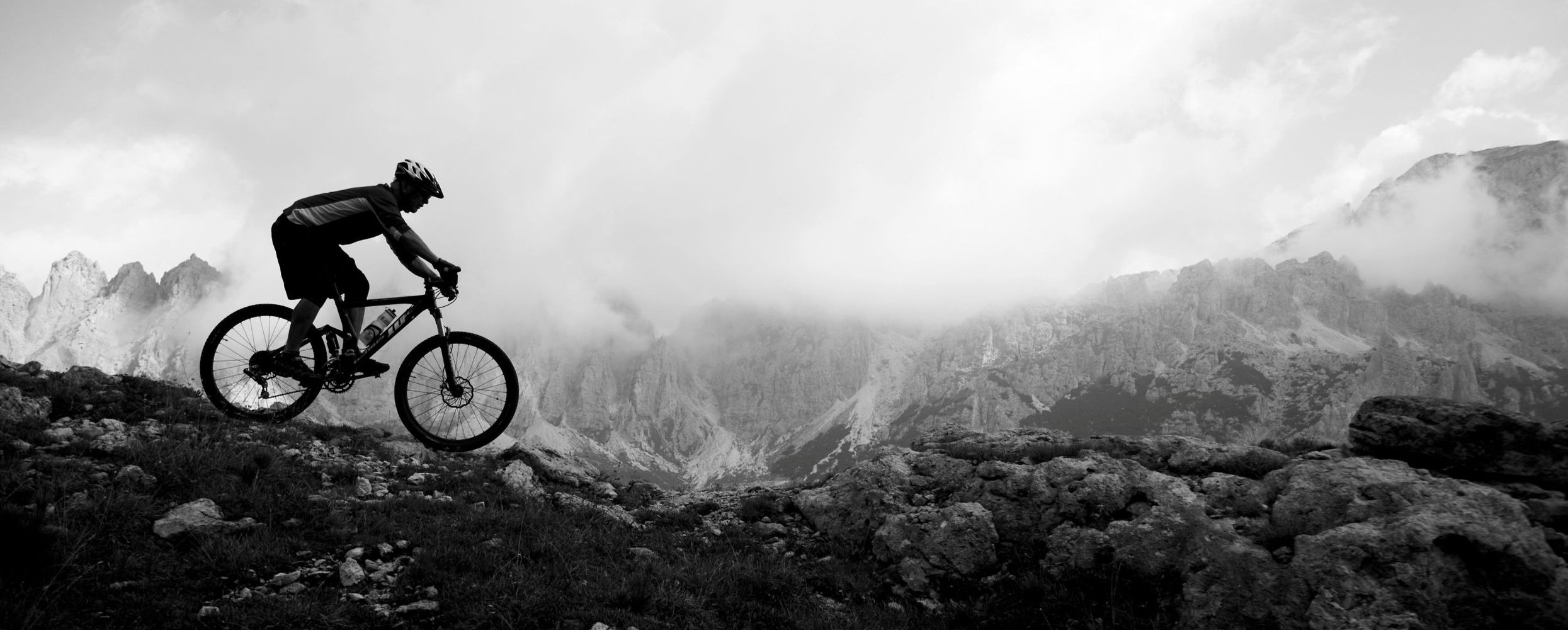 A person riding a bike down a mountain