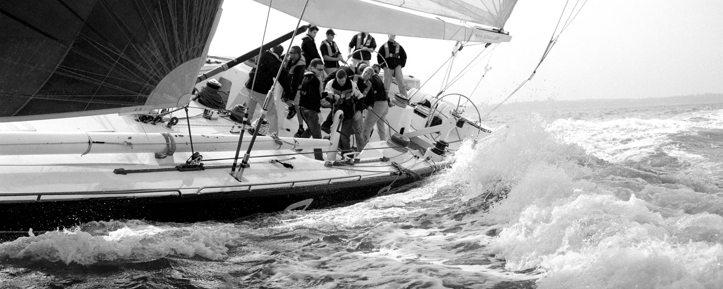 A large group of sailors navigating waves