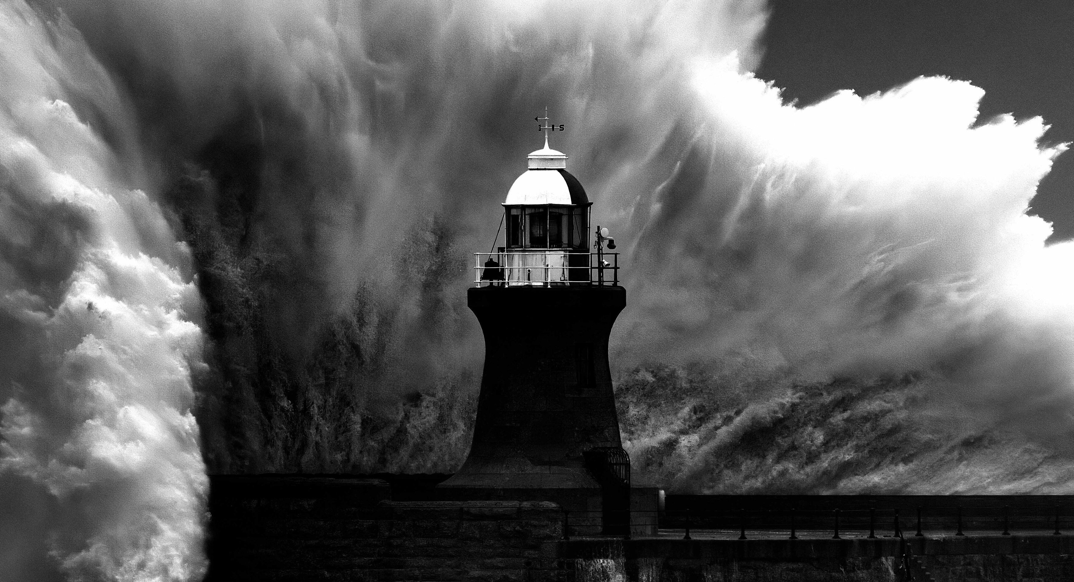 Lighthouse with huge wave crashing against it