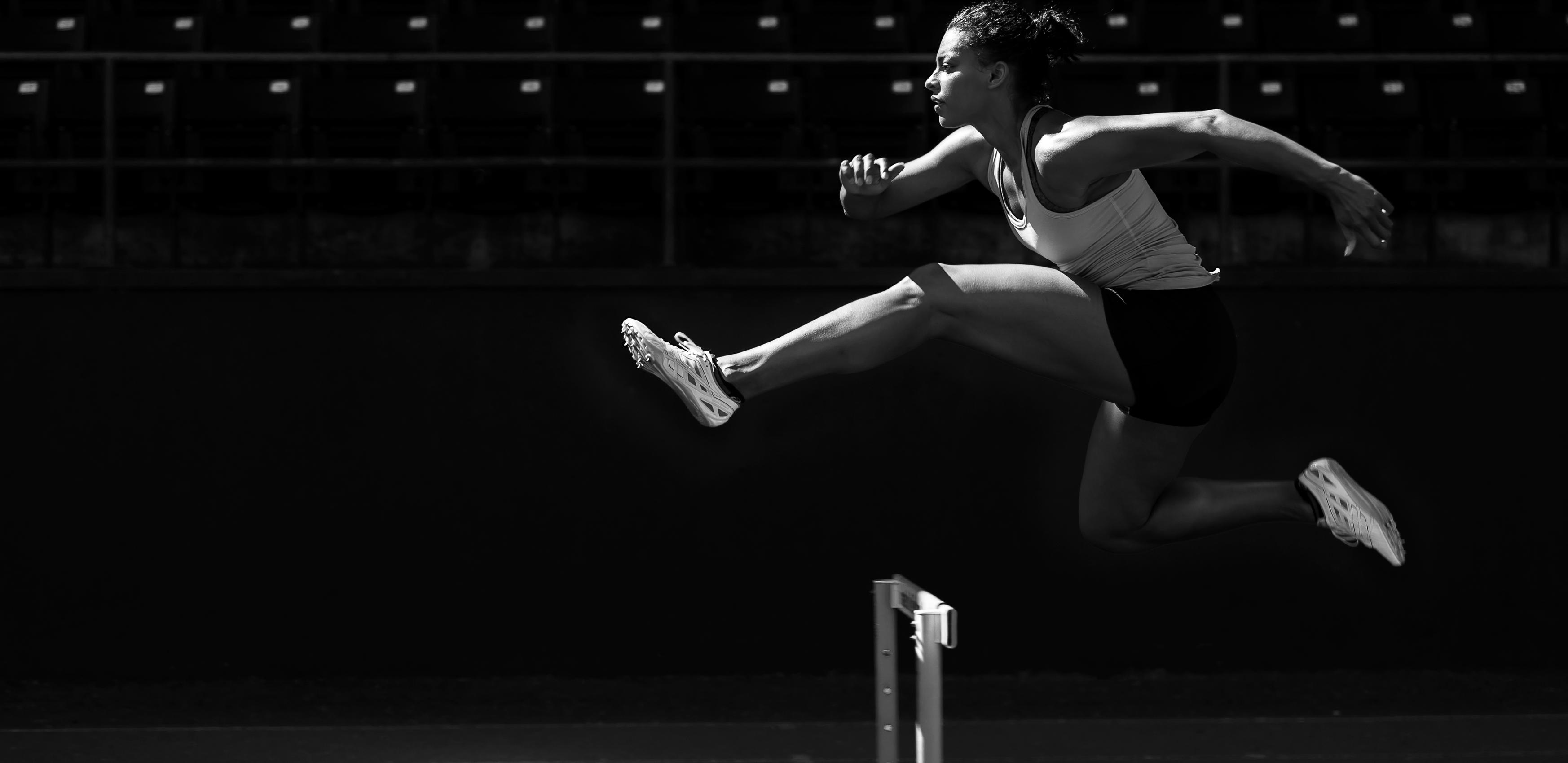 Person jumping a hurdle