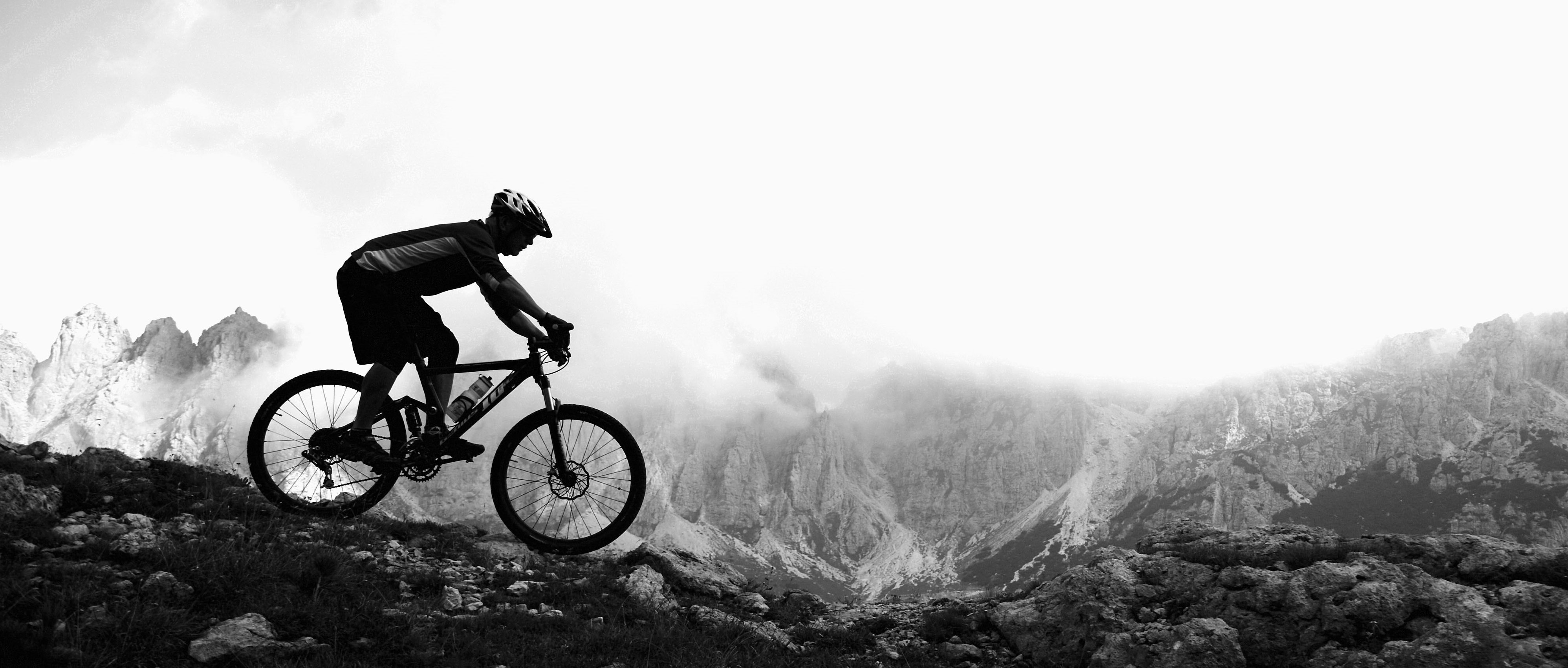 Person cycling across landscape