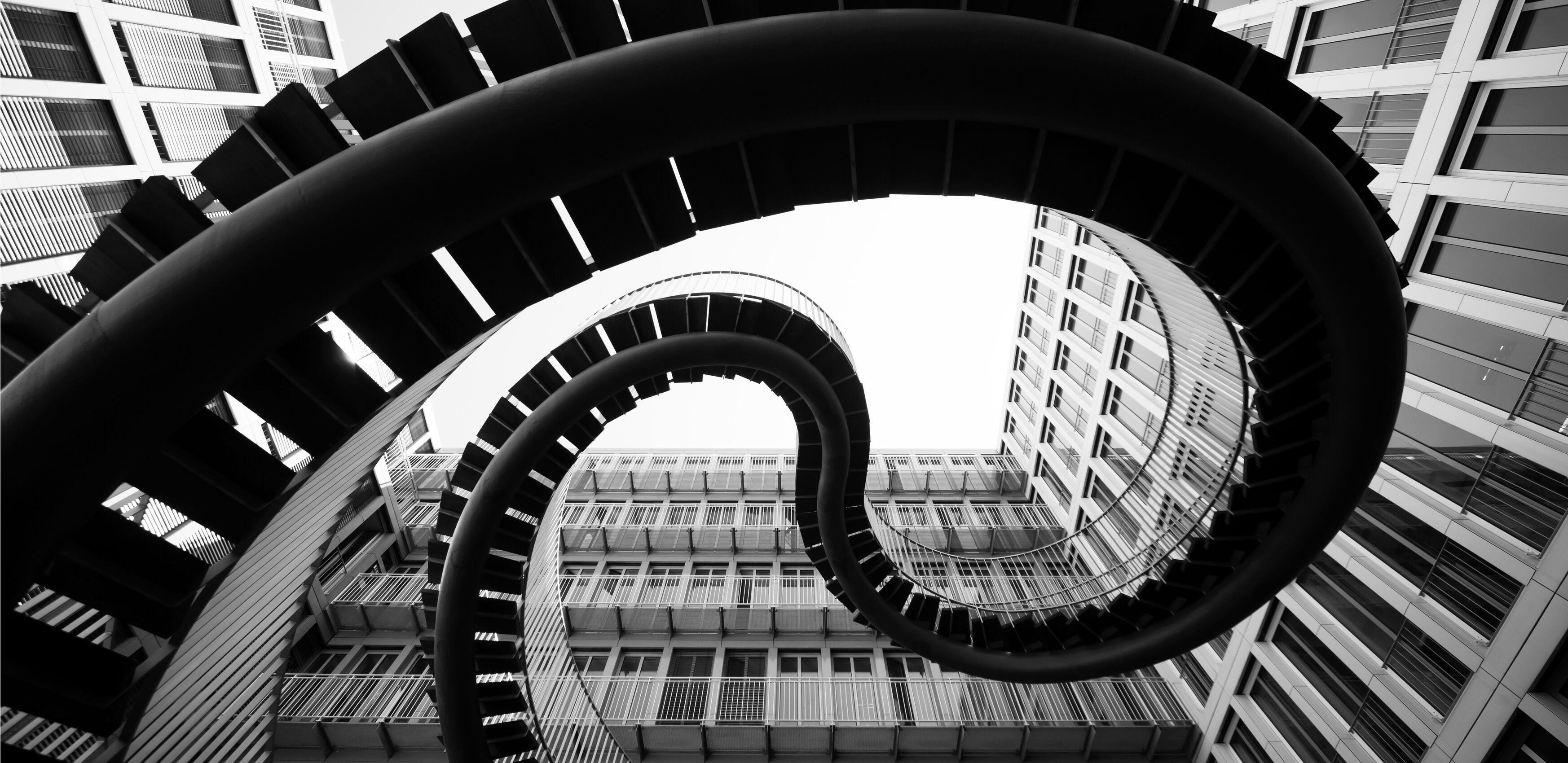 Spiral staircase going through the middle of a modern building