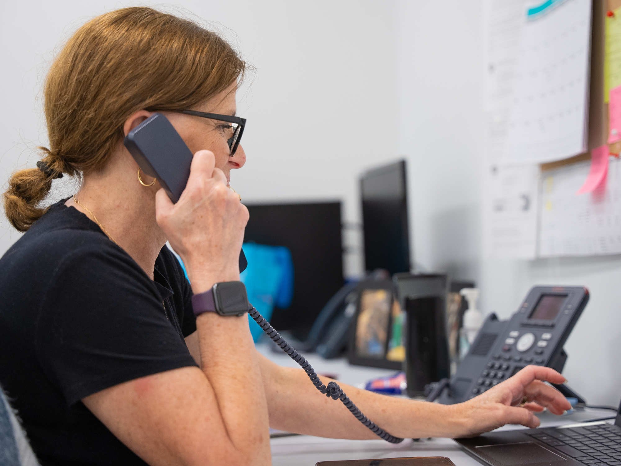 Clinical panelist recruiter answering a call with phone in hand
