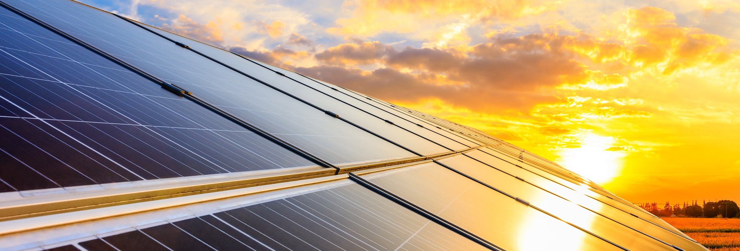 Solar panels on sunset sky background