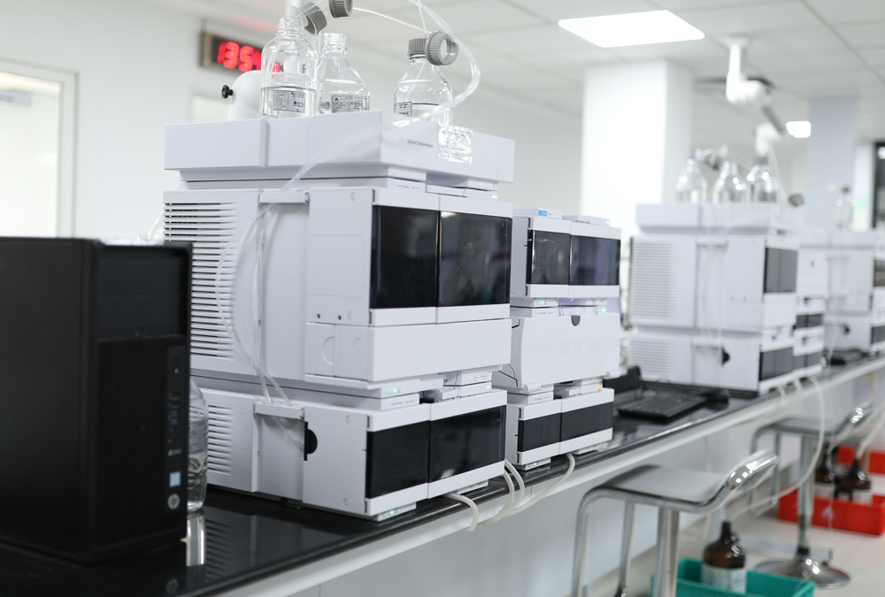 A laboratory with a row of connected scientific equipment used for complex analysis research.