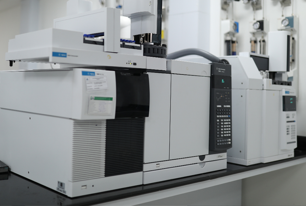 The image shows a scientific laboratory with equipment for chemical analysis and testing.