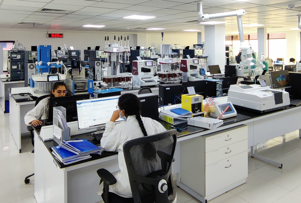 Two scientists conduct research at a lab using sophisticated equipment.
