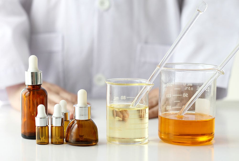 A scientist is analyzing a test outcome using various liquids and beakers.
