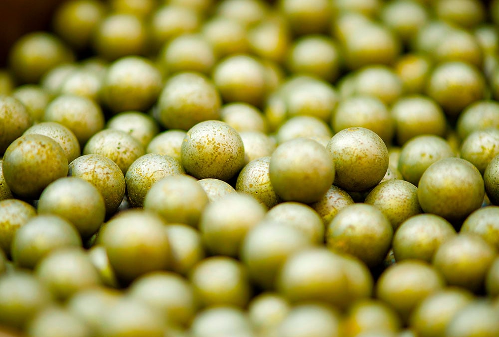 A pile of small, golden spheres, potentially used for testing or analysis.