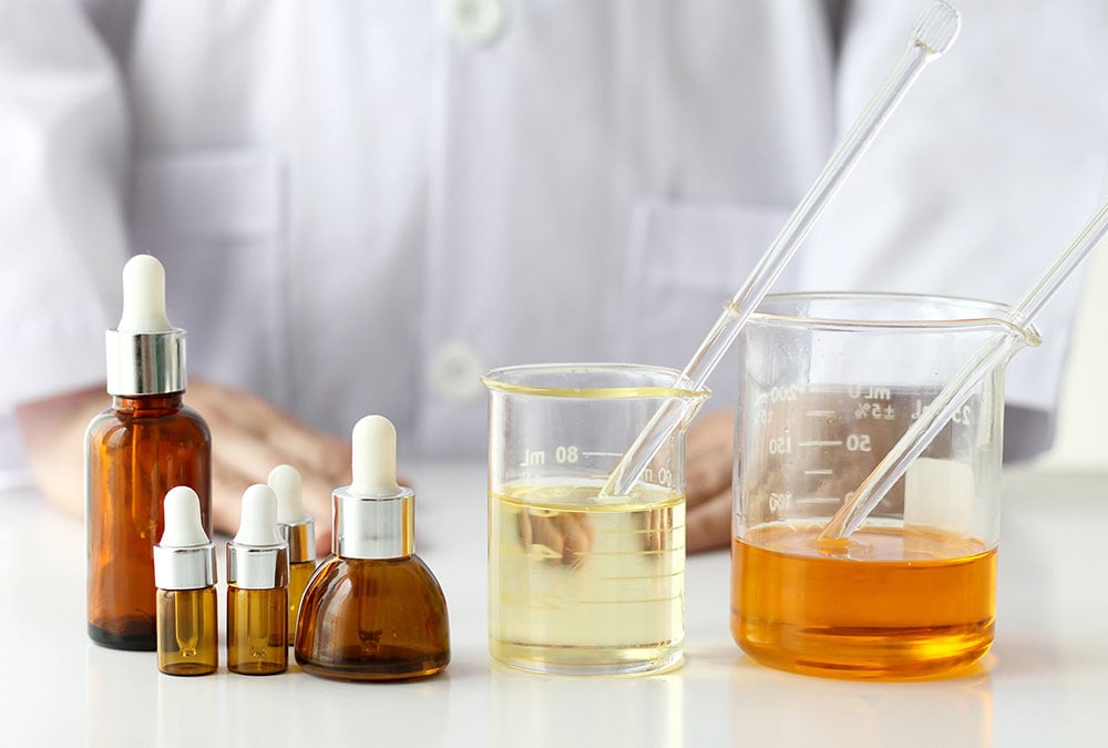 A lab setting with liquid samples and glass beakers in the process of testing and analysis.