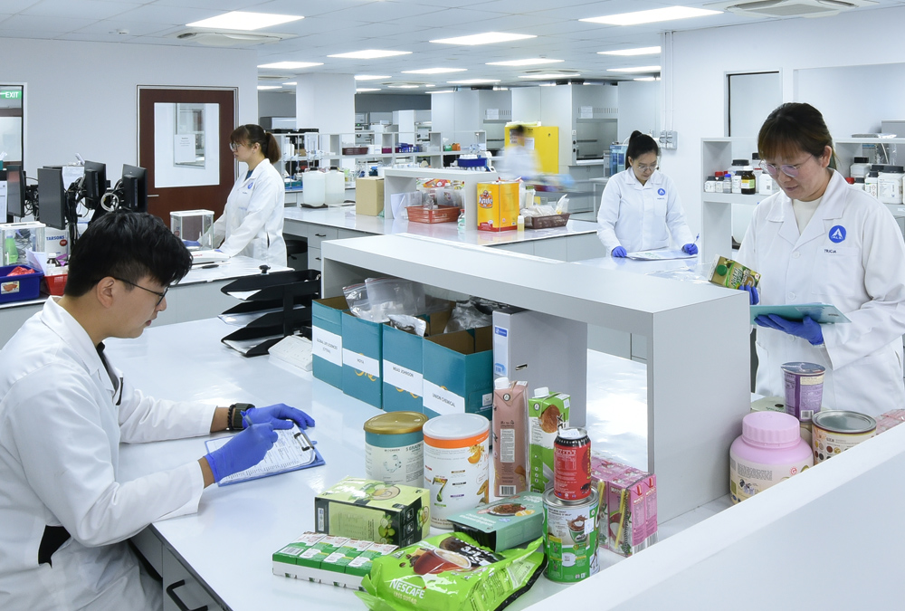 Five people conduct product research in a lab setting.