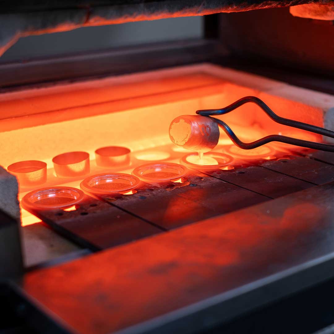 Tongs removing crucible from furnace in a Metallurgy laboratory
