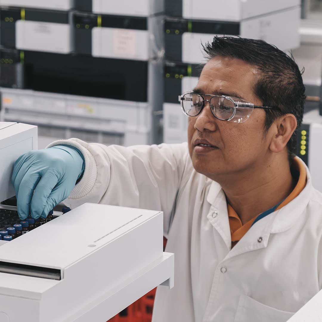 Laboratory technician uploading samples for analysis