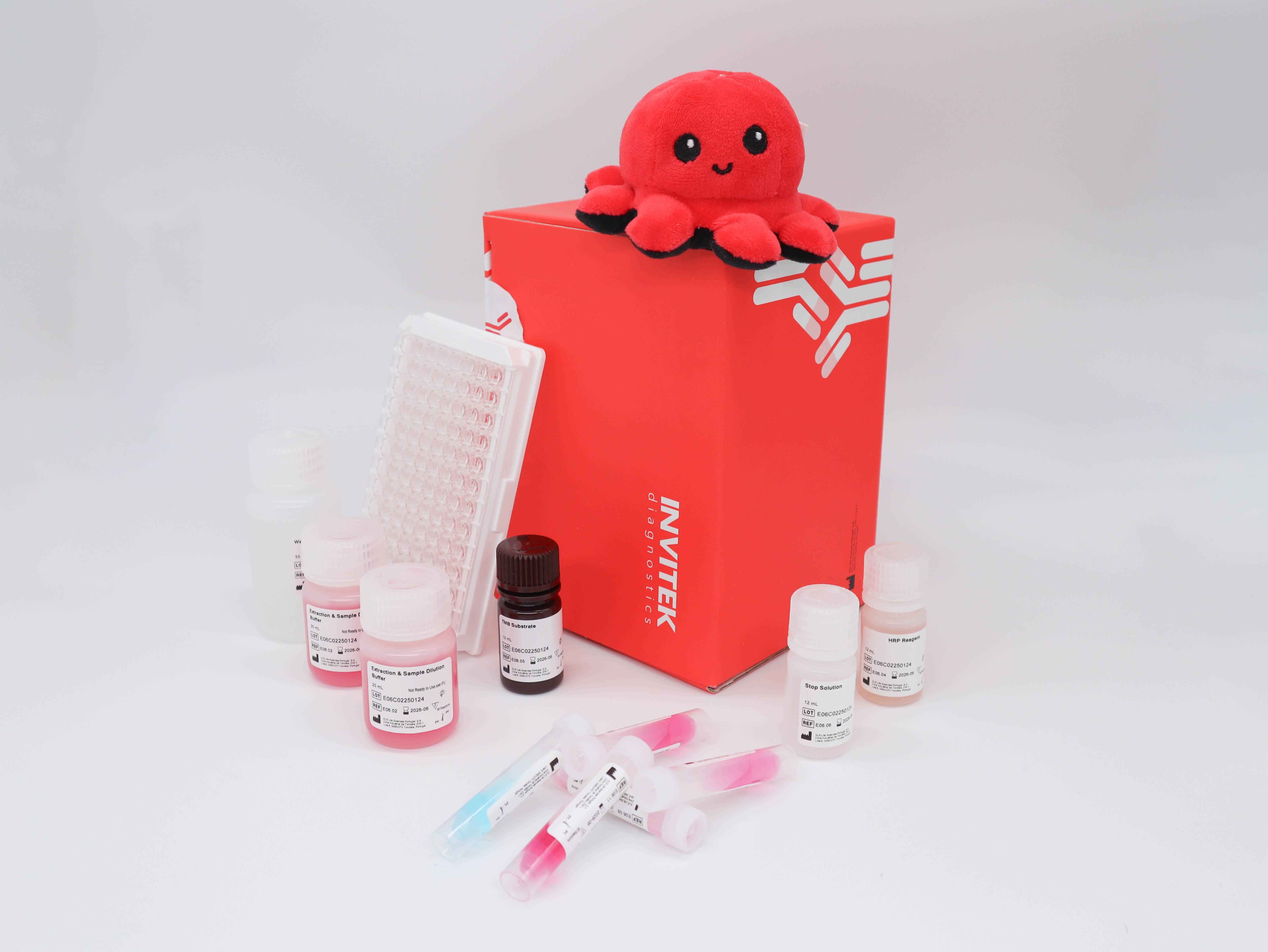Red Invitek Diagnostics InviLisa Mustard ELISA Kit box behind reagent bottles and reagent vials with an antibody-coated 96-well plate next to the box.