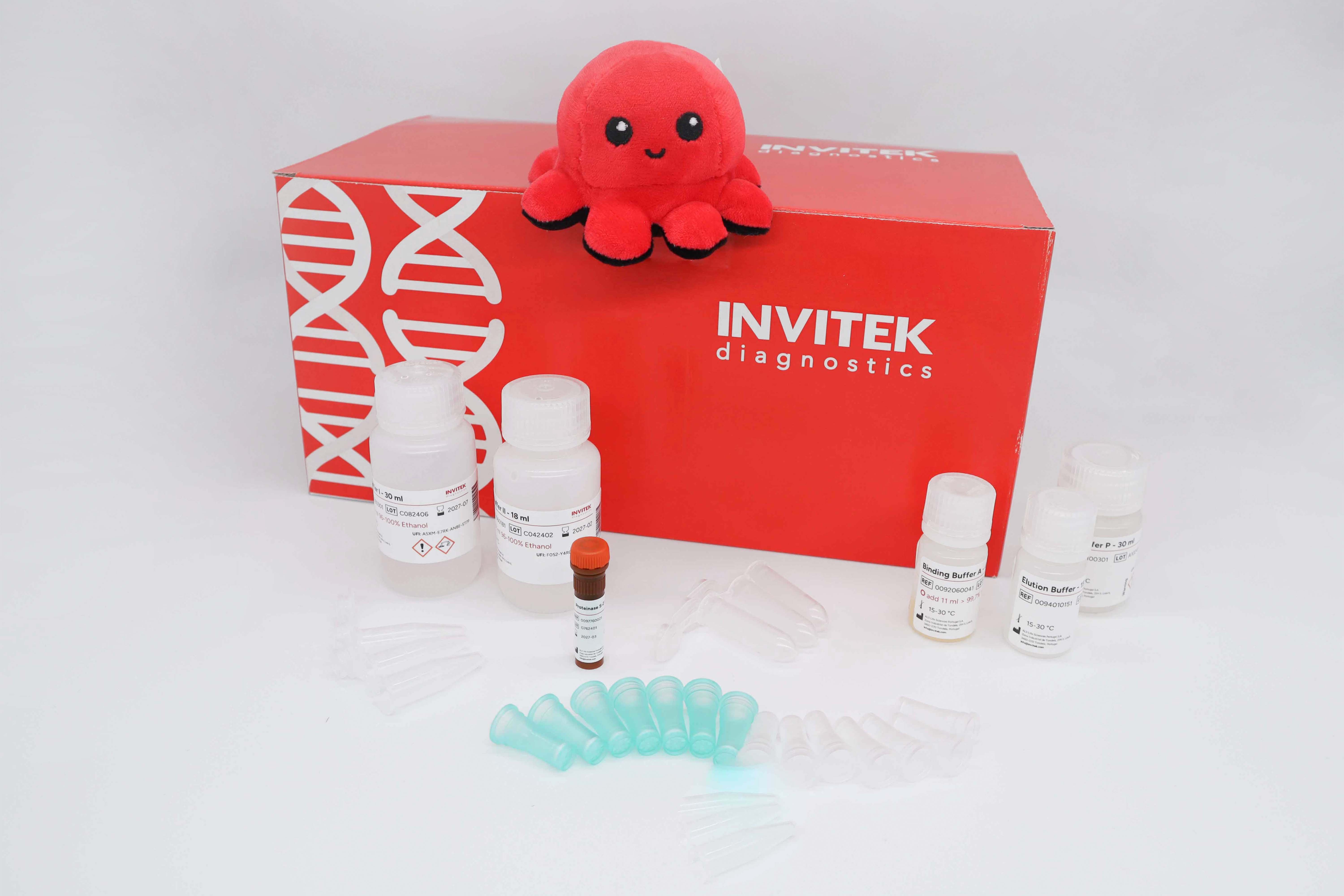 Red Invitek Diagnostics InviSorb Spin Plant Mini Kit box behind reagent bottles, and green prefilters with spin filters, and tubes laying scattered in front.