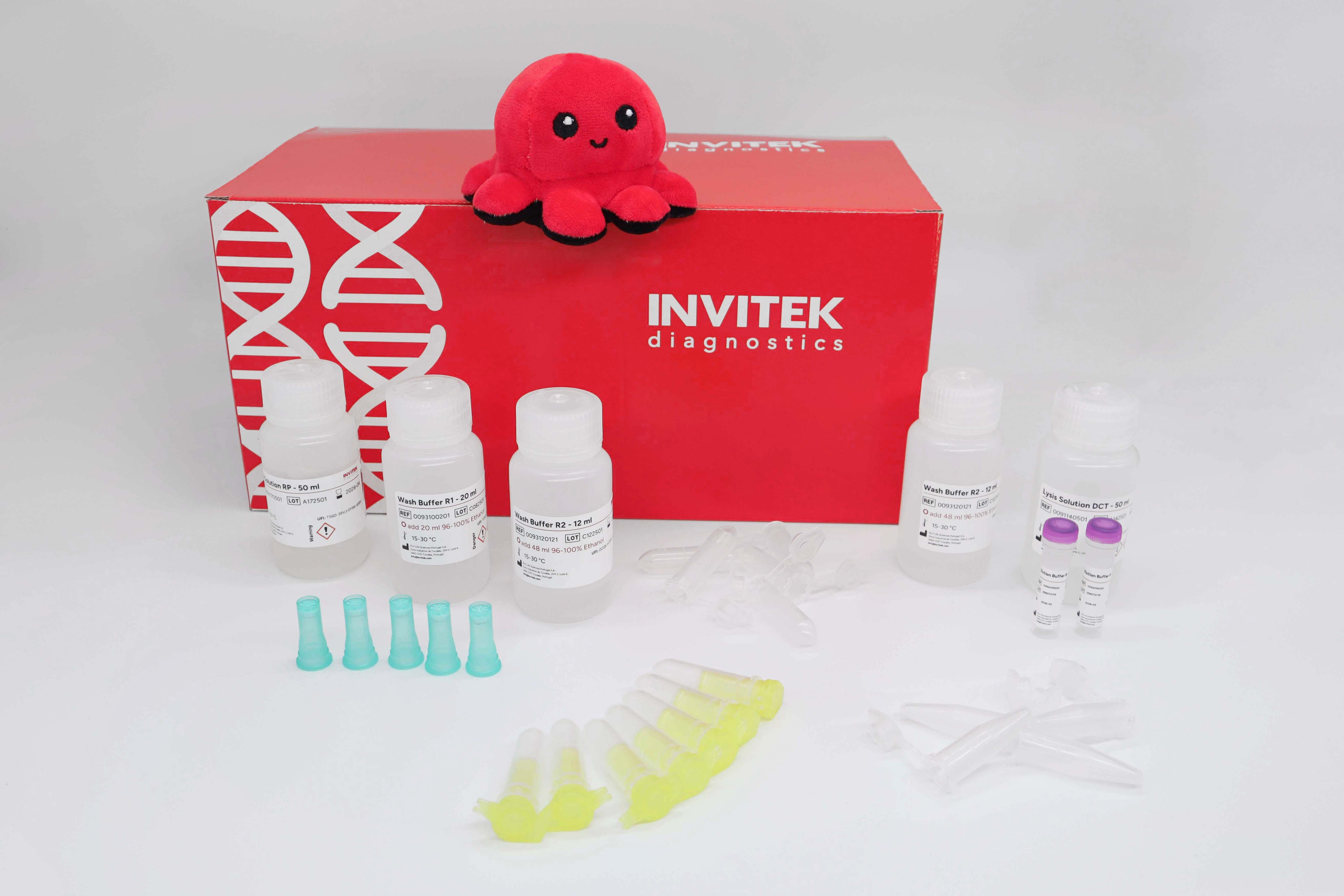 Red Invitek Diagnostics InviTrap Spin Plant RNA Mini Kit box behind reagent bottles, and color-coded reagent vials with green prefilters, yellow spin filters, and tubes laying scattered in front.