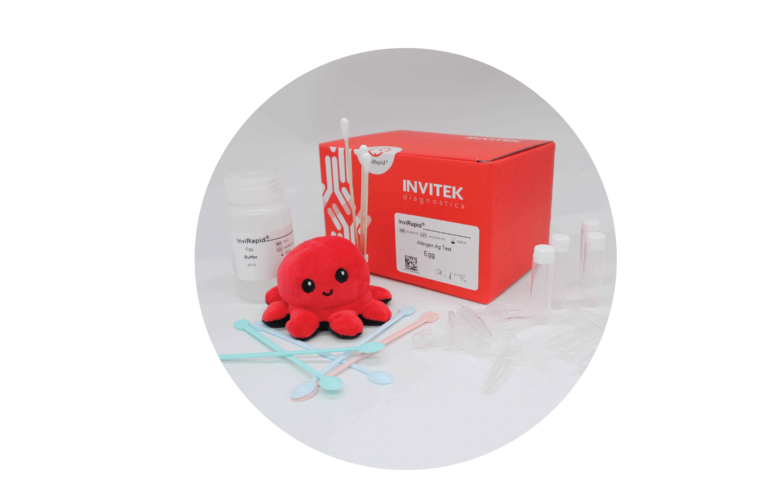 Red Invitek Diagnostics InviRapid Egg Allergen Ag Test box behind a buffer bottle, swabs, and sample tubes with scoops, droppers and tubes laying scattered in front.