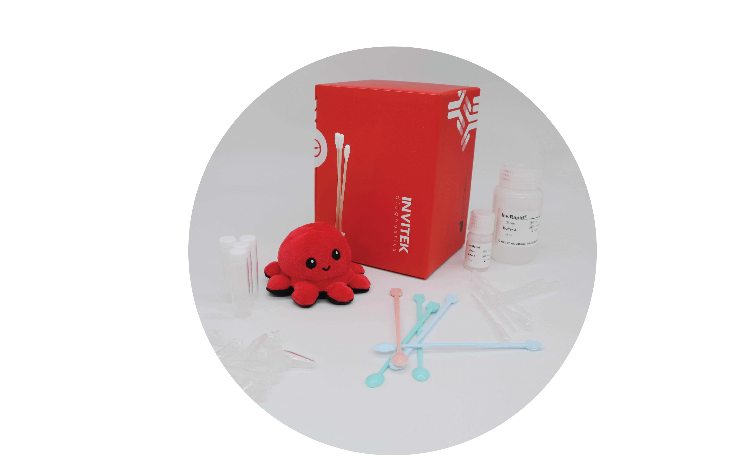 Red Invitek Diagnostics InviRapid Gluten Allergen Ag Test box behind swabs next to buffer bottles and sample tubes with scoops, droppers and tubes laying scattered in front.
