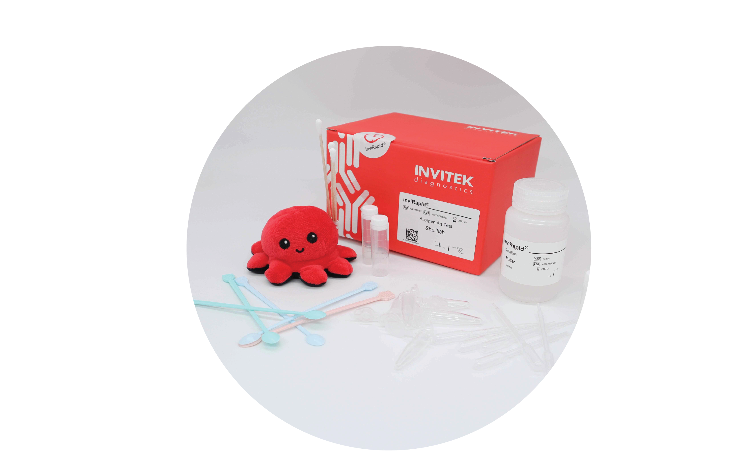 Red Invitek Diagnostics InviRapid Shellfish Allergen Ag Test box behind a buffer bottle, sample tubes, and swabs with scoops, droppers and tubes laying scattered in front.