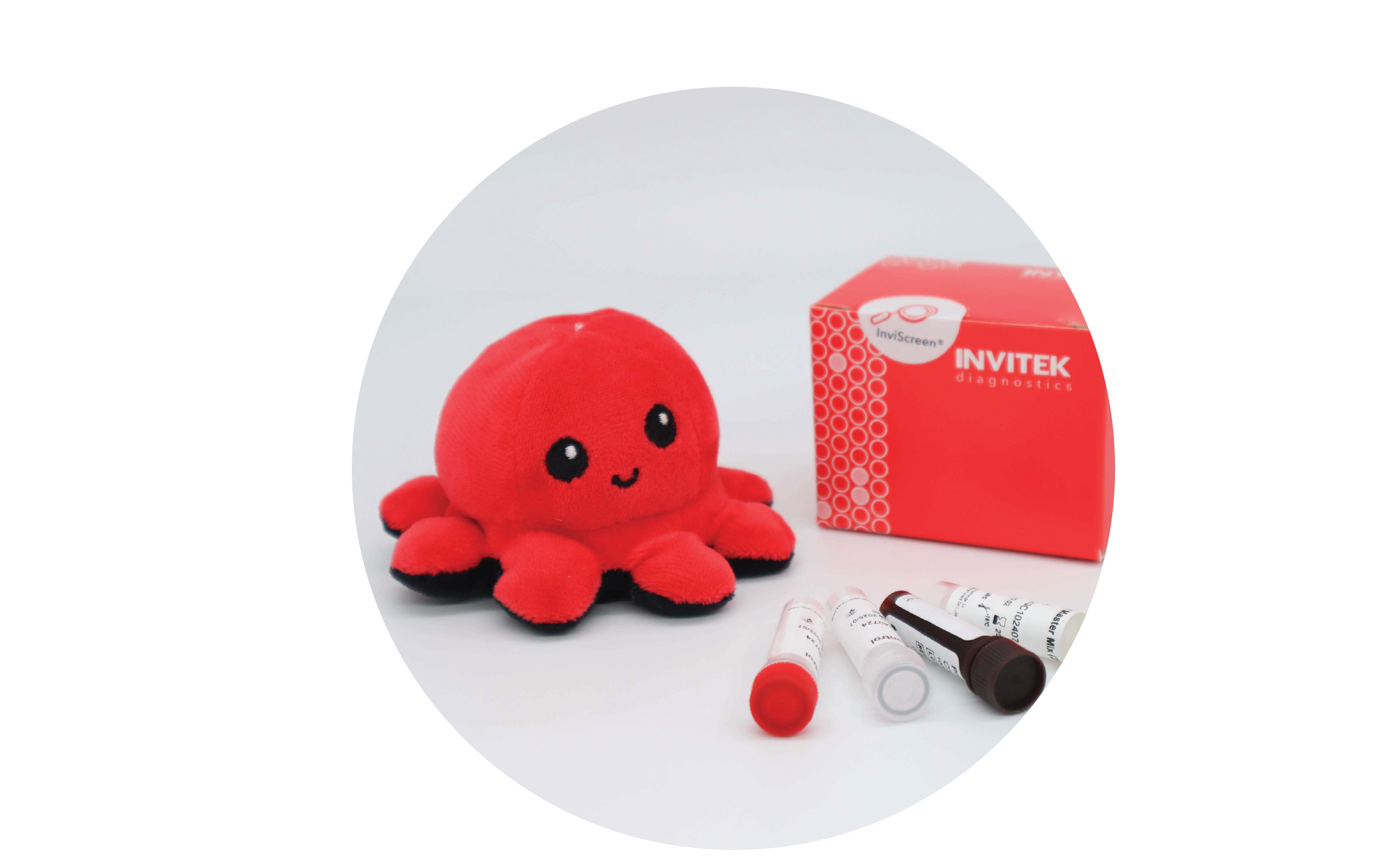 InviScreen STEC detection kit: plush octopus at left, INVITEK box at right, five reagent vials (red, grey, brown, green caps) arranged in front.