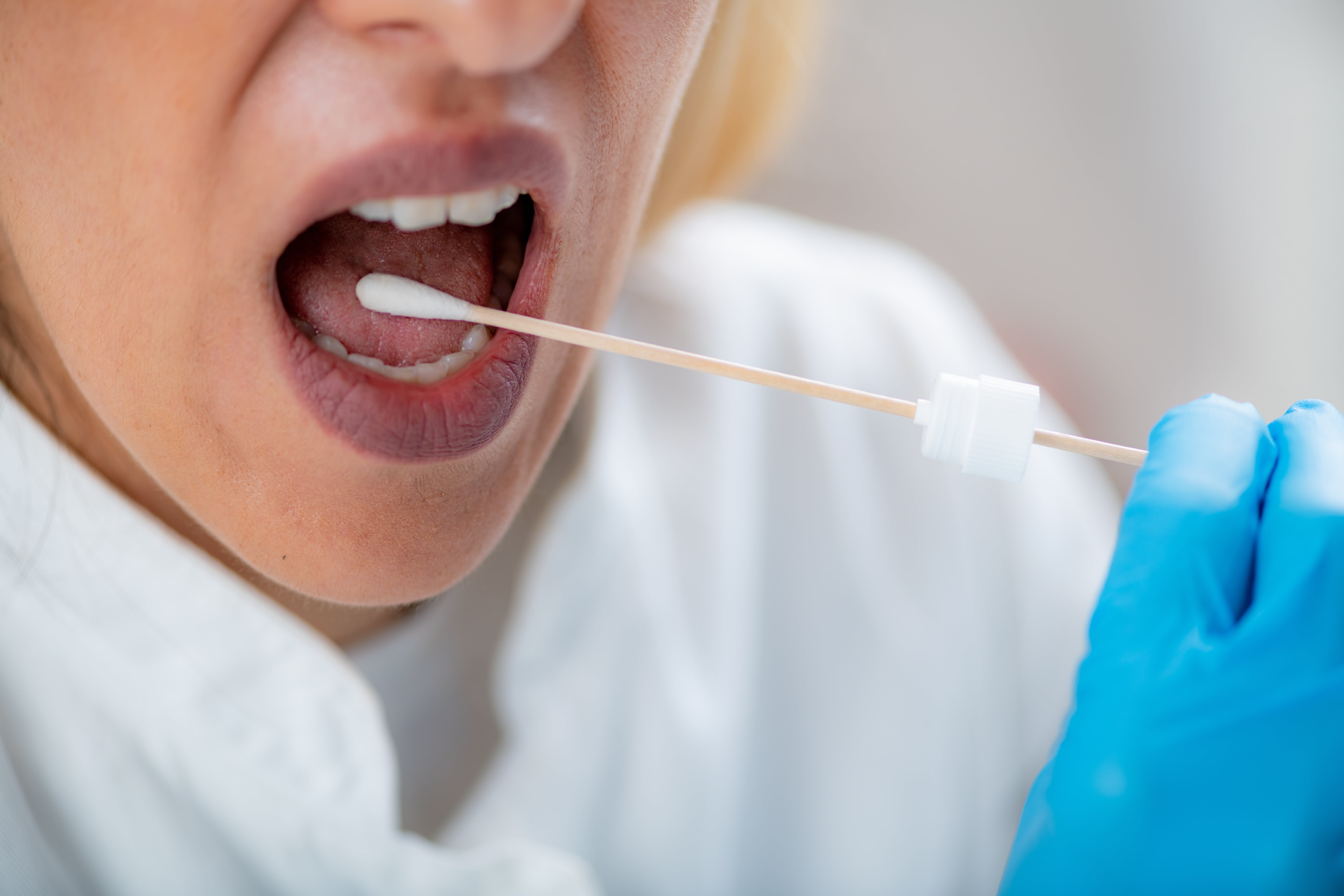 inserting swab into mouth