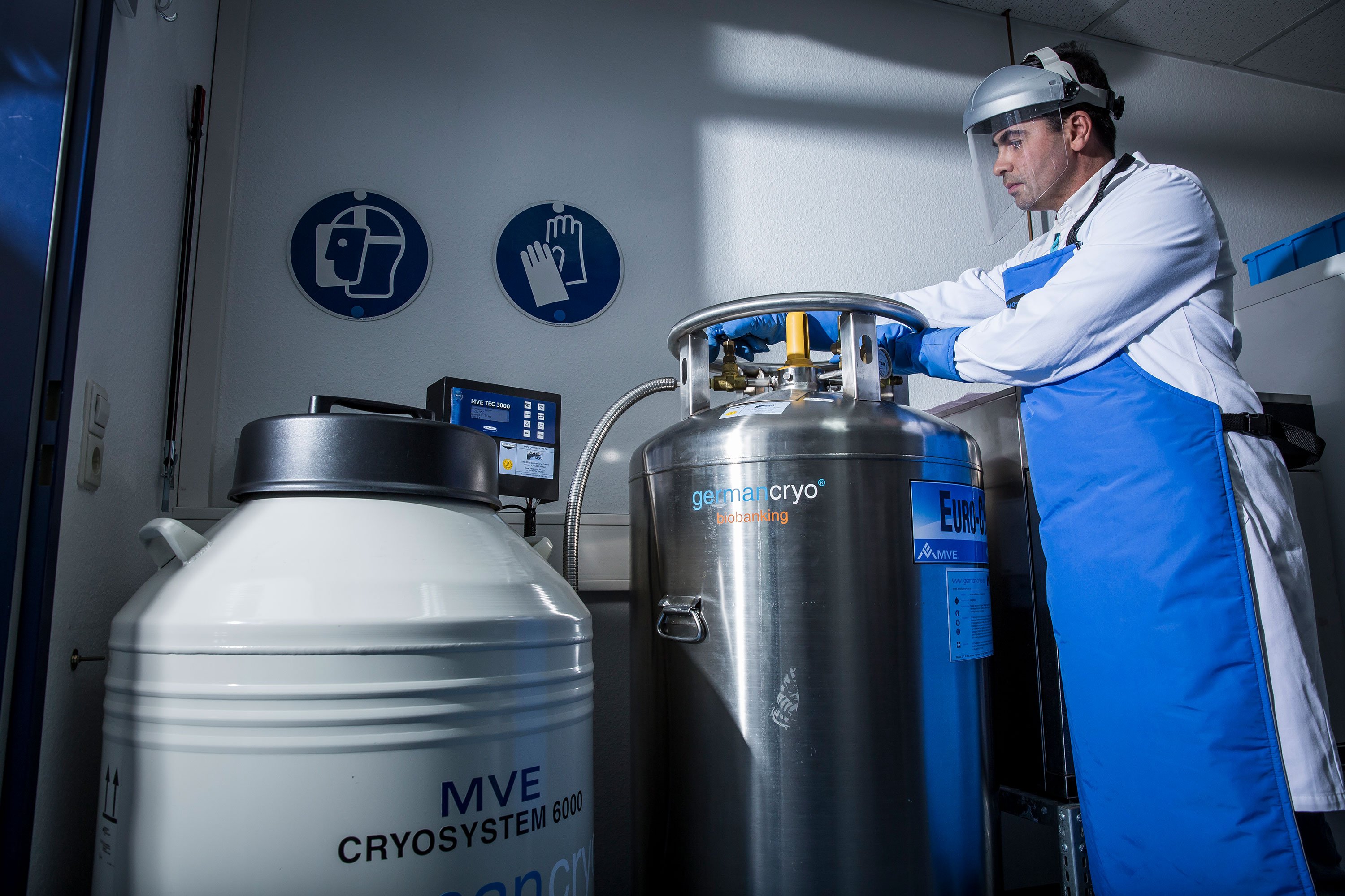 A scientist working in a laboratory with a vessel