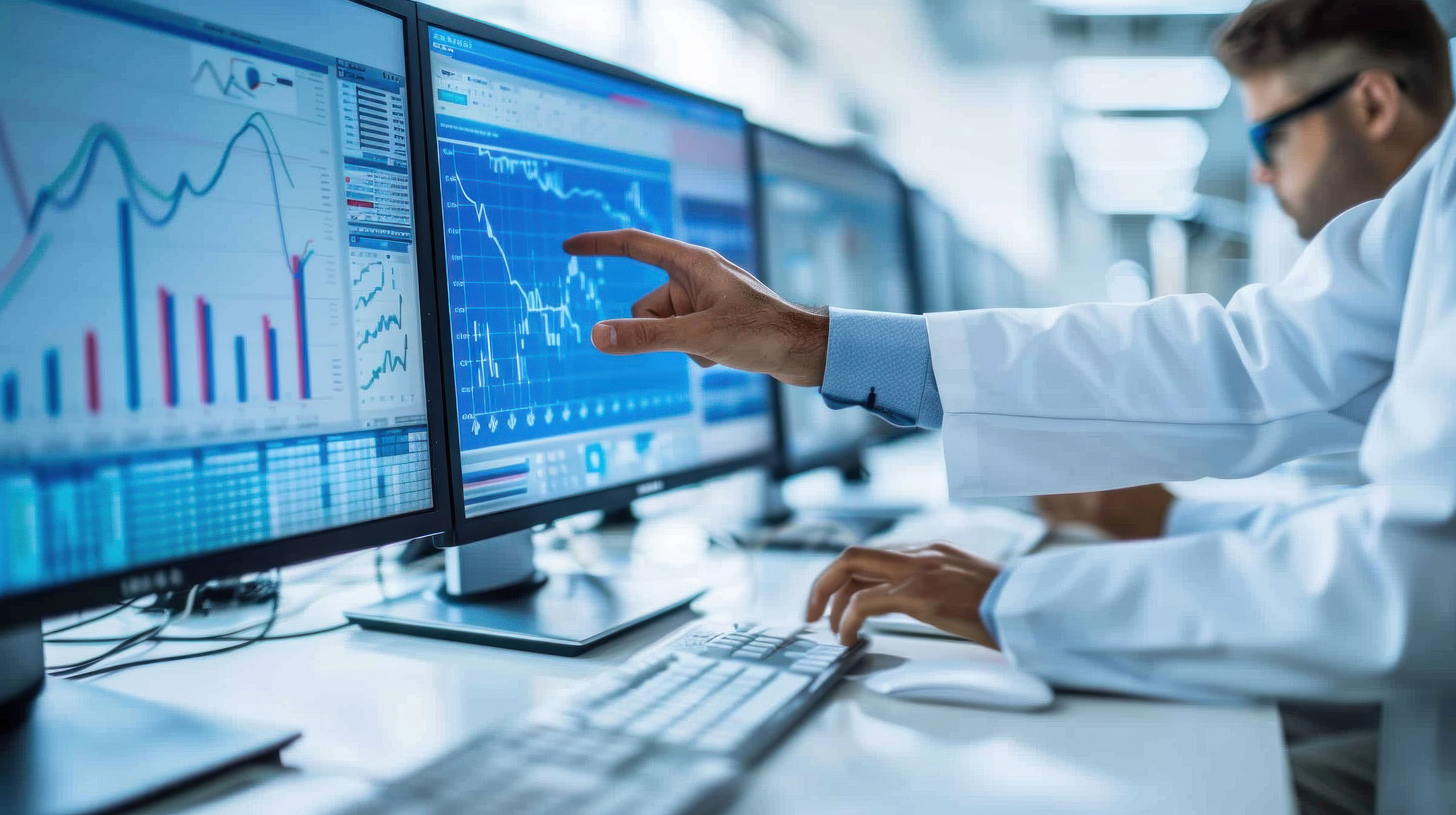 Clinical biostatistician analyzing statistical data on multiple screens, highlighting graphs and metrics