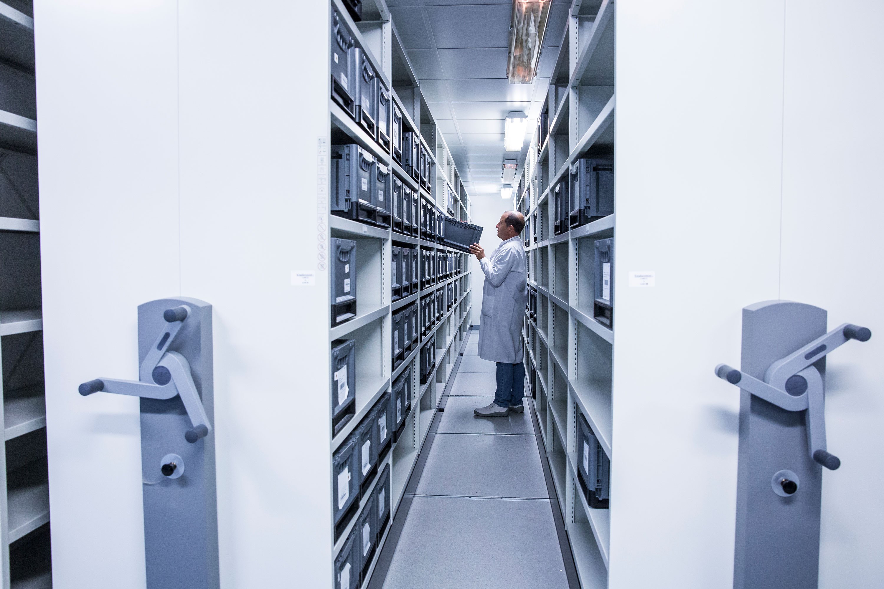 Man in warehouse managing logistics and depot solutions for clinical trial supplies