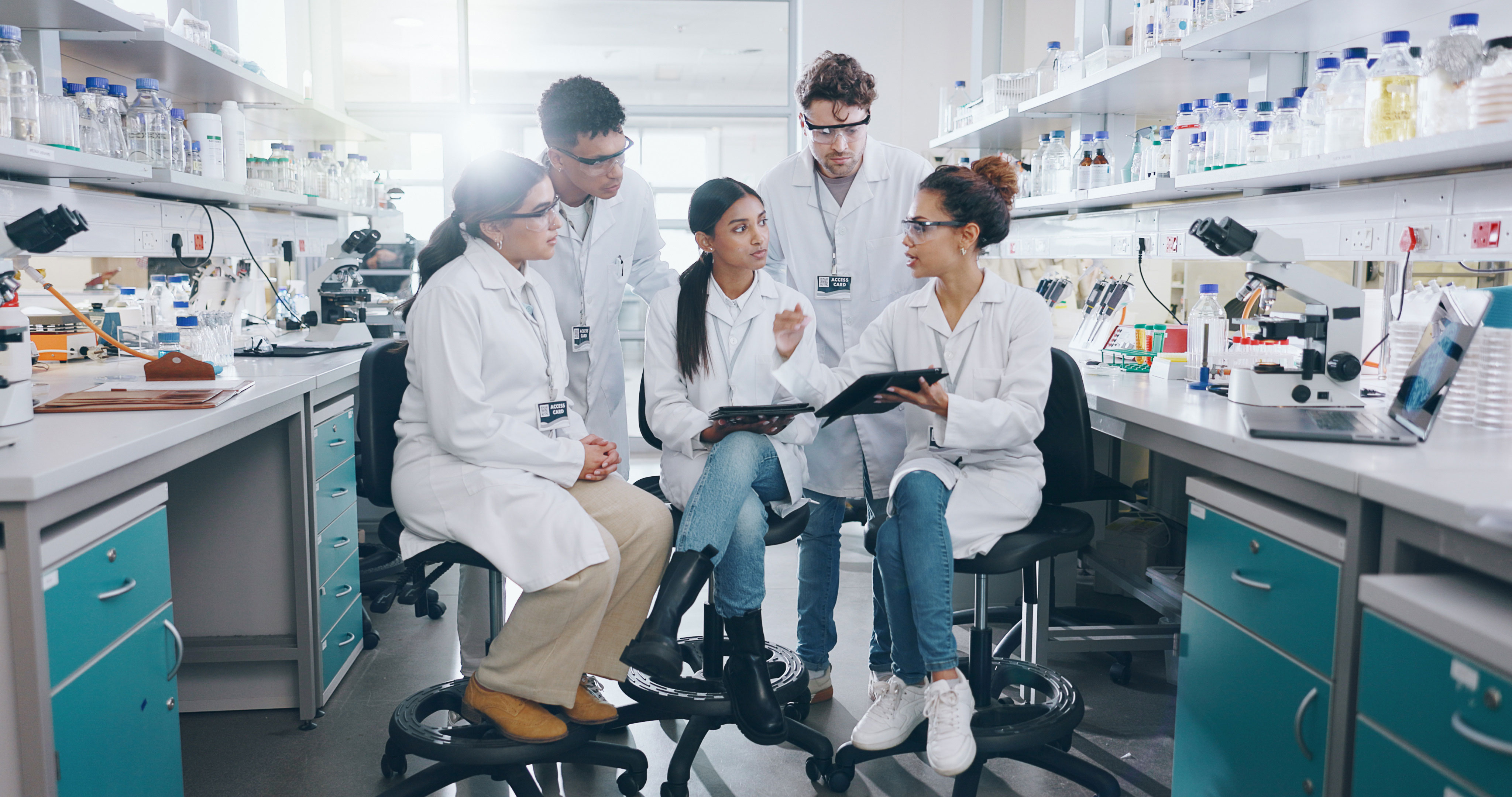 Group of people in laboratory with tablets discussing