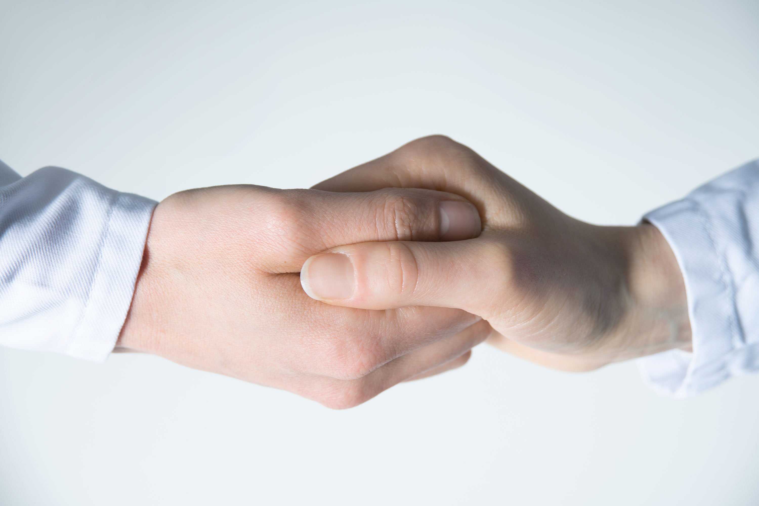Two people working together hand in hand