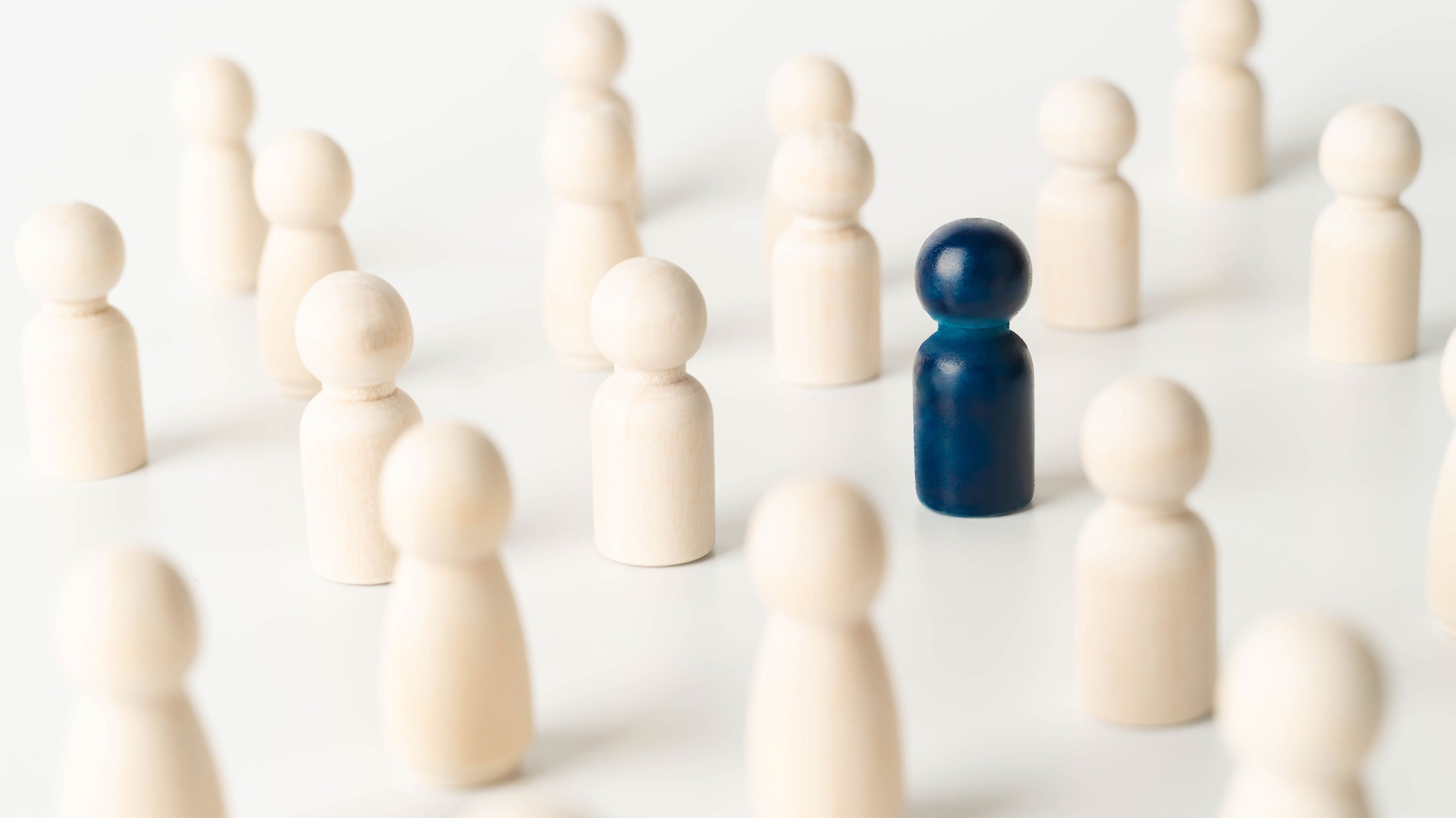 Blue figure in the middle of white figures, representing an outlier