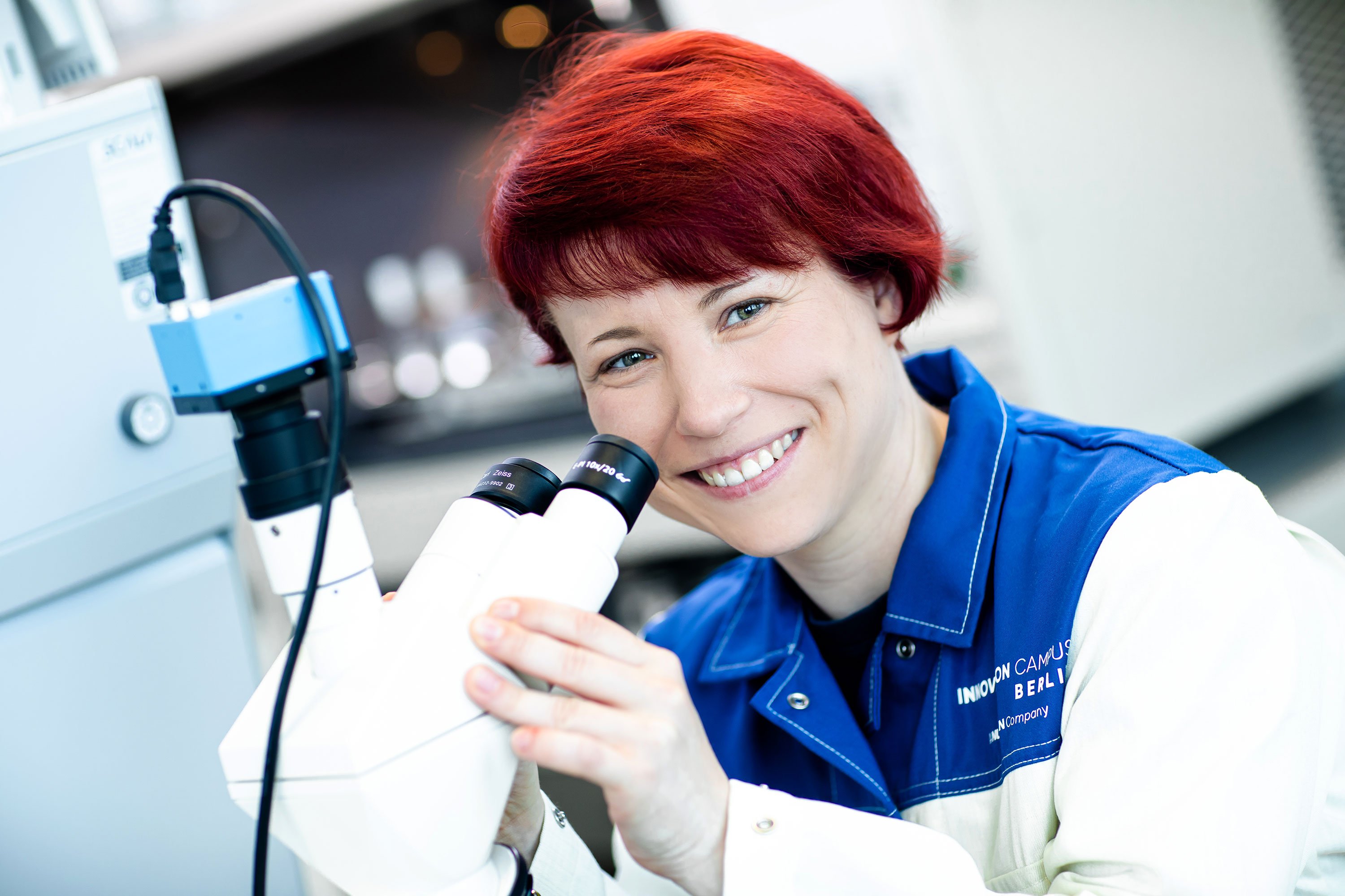 Lab professional operating a microscope