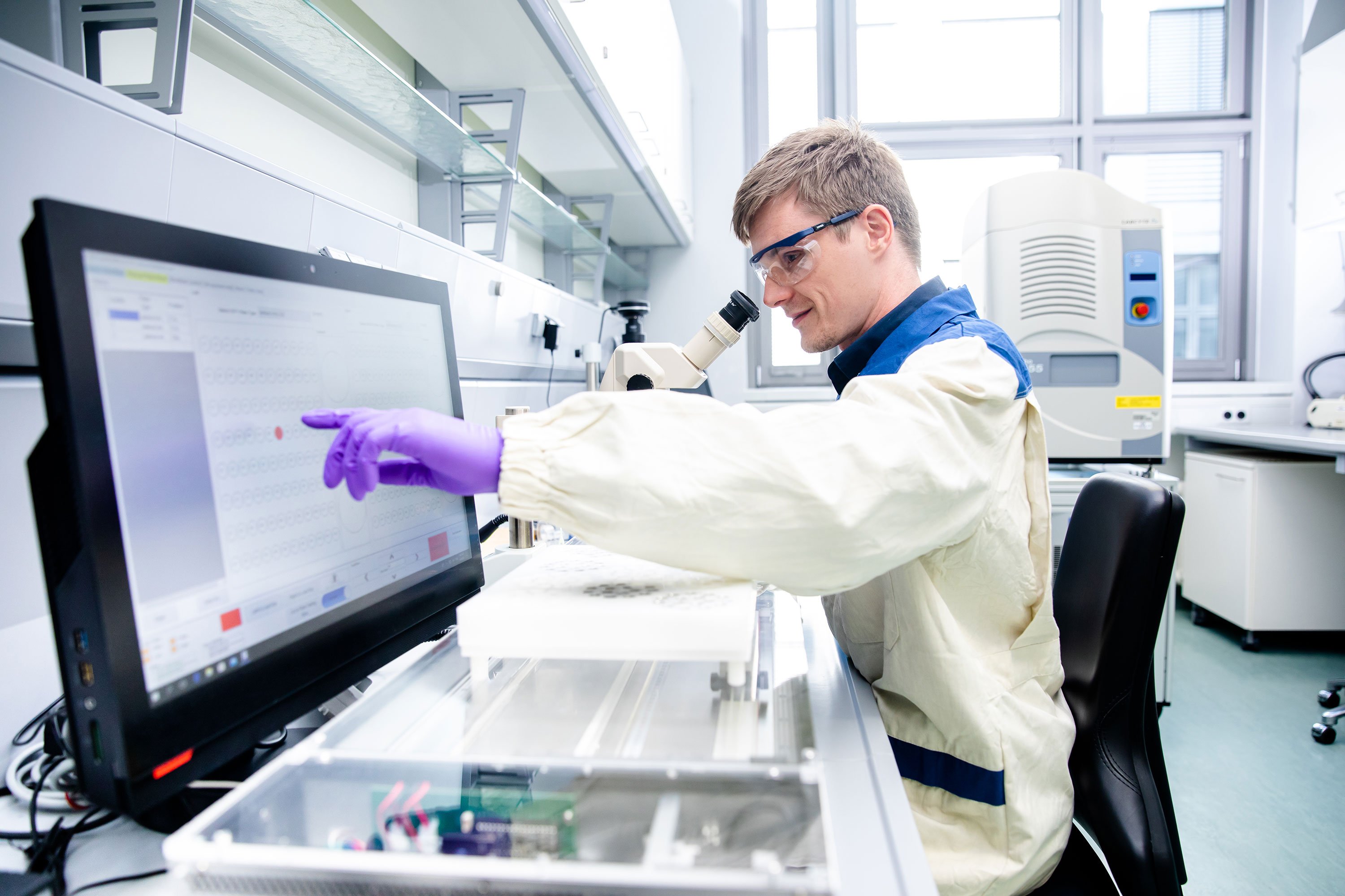 A scientist harvesting crystals for X-ray fragment screening campaign