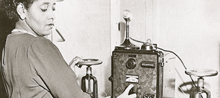 vintage photograph of young african american female worker at machine