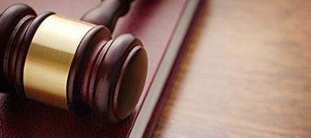 gavel and book on wooden table
