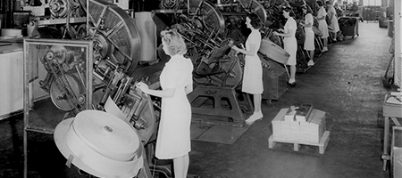 vintage photo of women working at machines in united states tobacco facility
