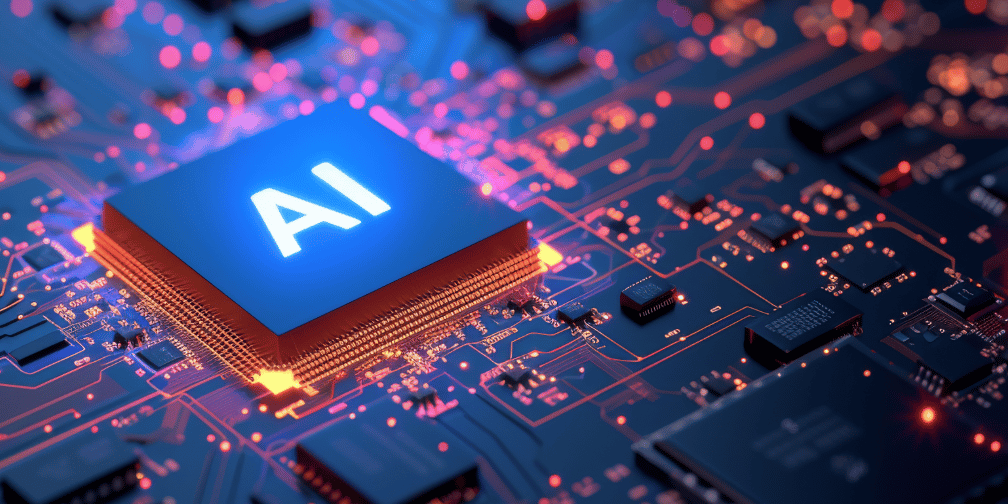 Close-up of a glowing “AI” microchip set on a circuit board, with blue and orange lights highlighting interconnected pathways and surrounding electronic components.