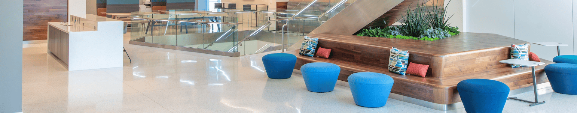 interior of headquarters common area with round colorful stools beside staircase