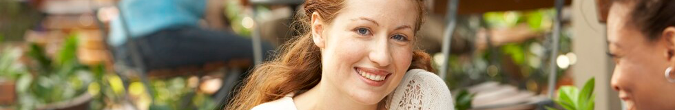 woman smiling in outdoor cafe