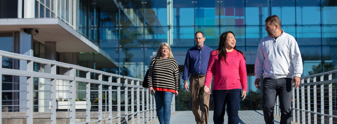 group of employees walking outside of headquarters building