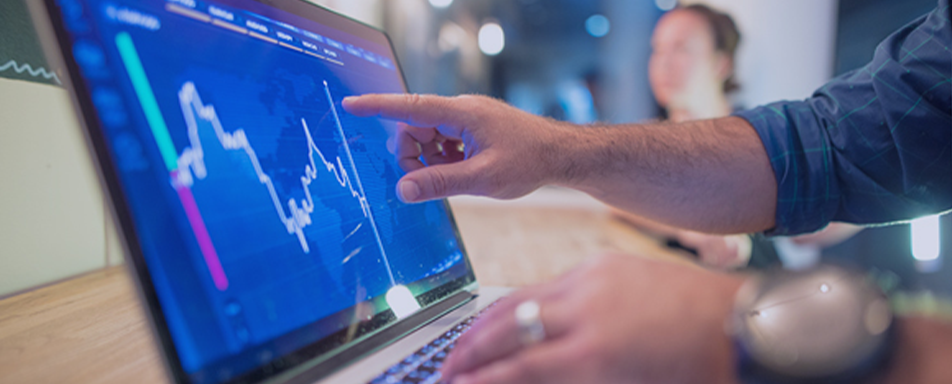 a man's hand working on a touch screen computer