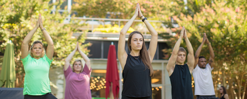 group of people practicing yoga outside