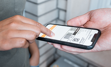 hand providing an e-signature for package delivery on a electronic device.