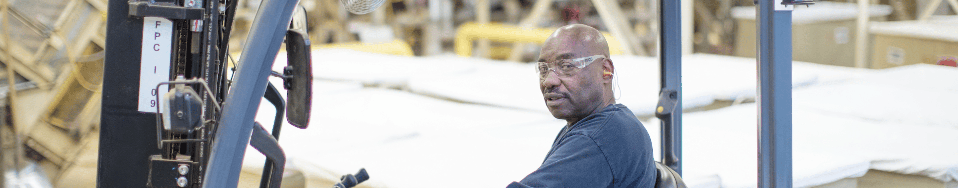 man on fork lift in manufacturing facility