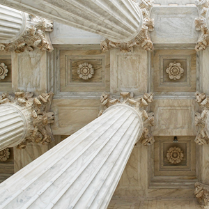 ceiling of a state building showing cream marble columns