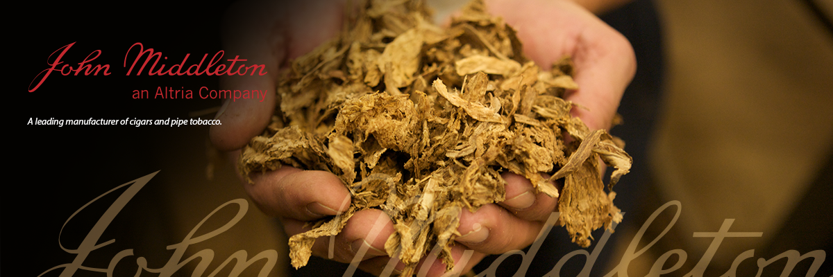 Cupped hands, holding unprocessed dried tobacco. "John Middleton" from the logo, in gold color partly overlays the bottom of the image, with the complete John Middleton logo in red at the top left.
