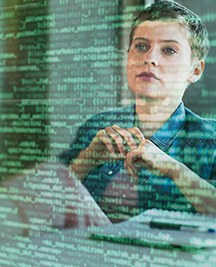Female professional looking at binary codes on glass at office