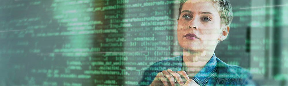 Female professional looking at binary codes on glass at office