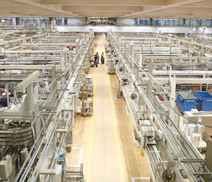 Overhead view of the floor of a manufacturing center showing machinery on either side of a clear center aisle
