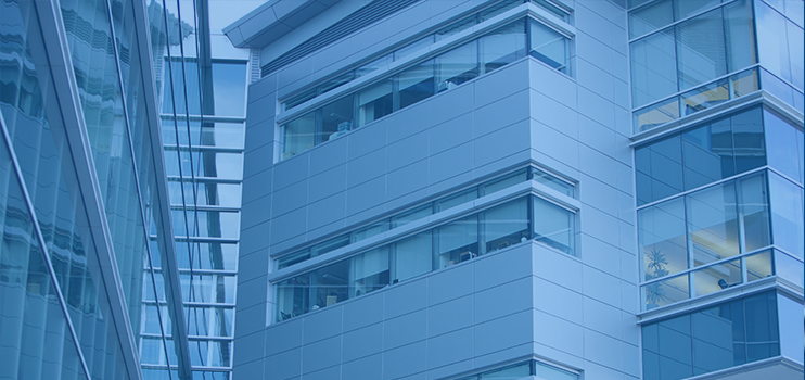 Close-up of the white external side wall of a building showing the windows of two levels